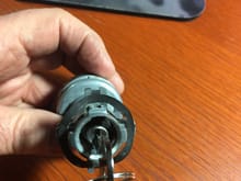 This is the off position. The key can be removed from the cylinder.  The copper button is present behind the top tang on the switch.