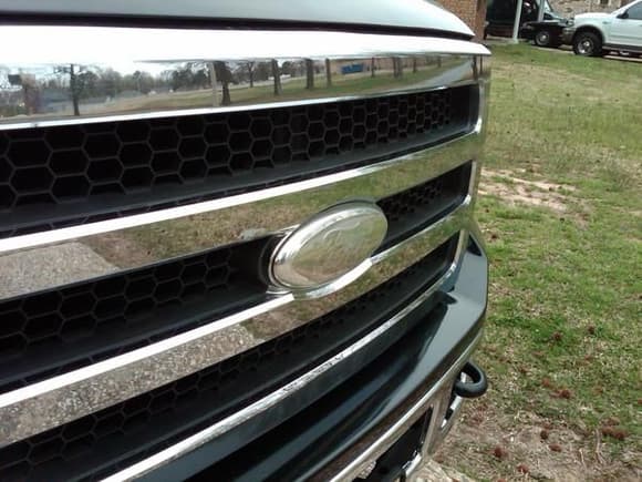 Excursion grille with color removed from emblem, just a little of the clear left to remove in this shot...