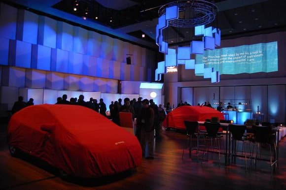 2010 Toyota Prius Debut Main Room with Two 2010 Models, still covered.