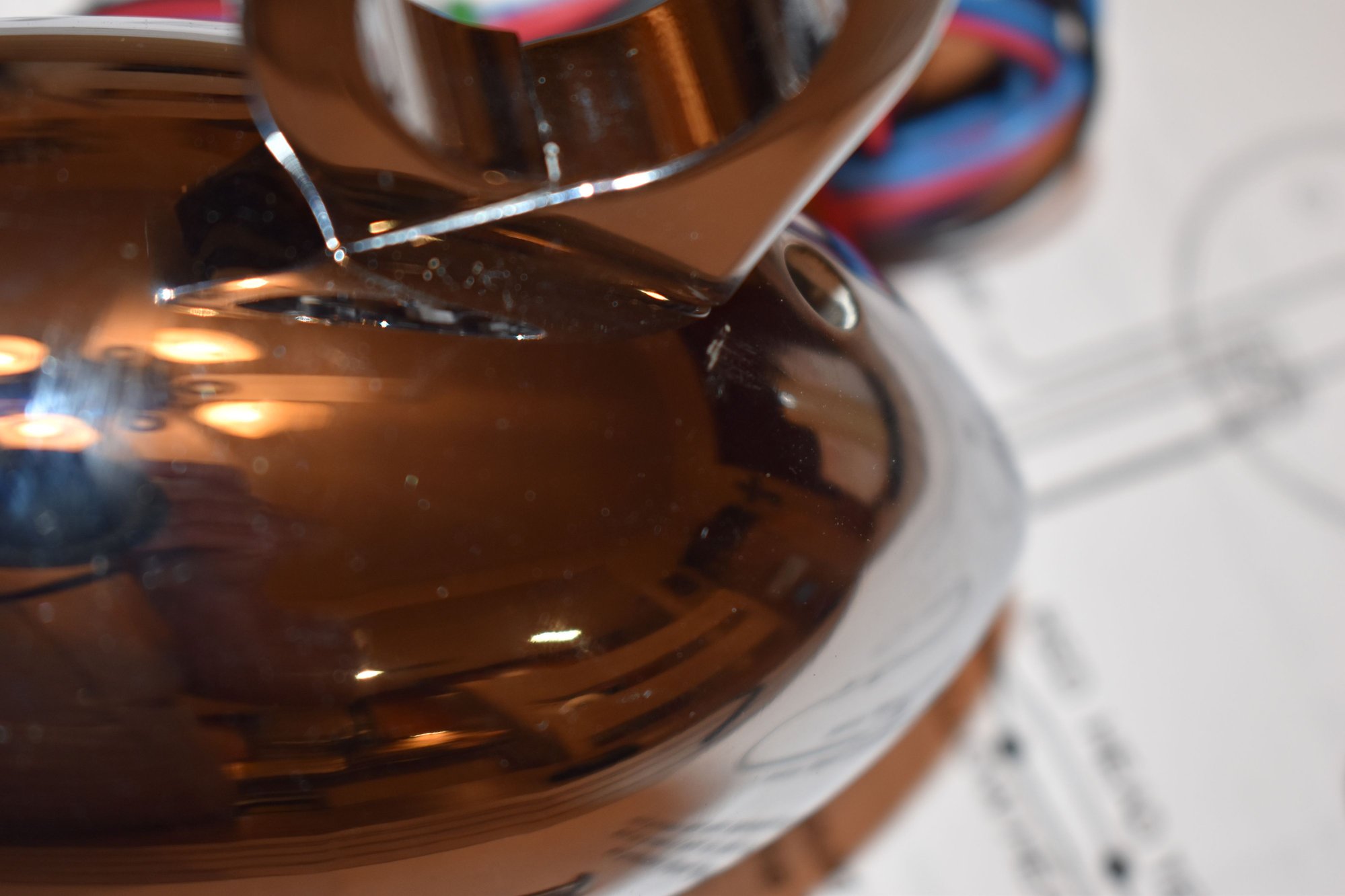 Slight scratch in the chrome next to the mount. On the bottom of the unit. Hard to see.