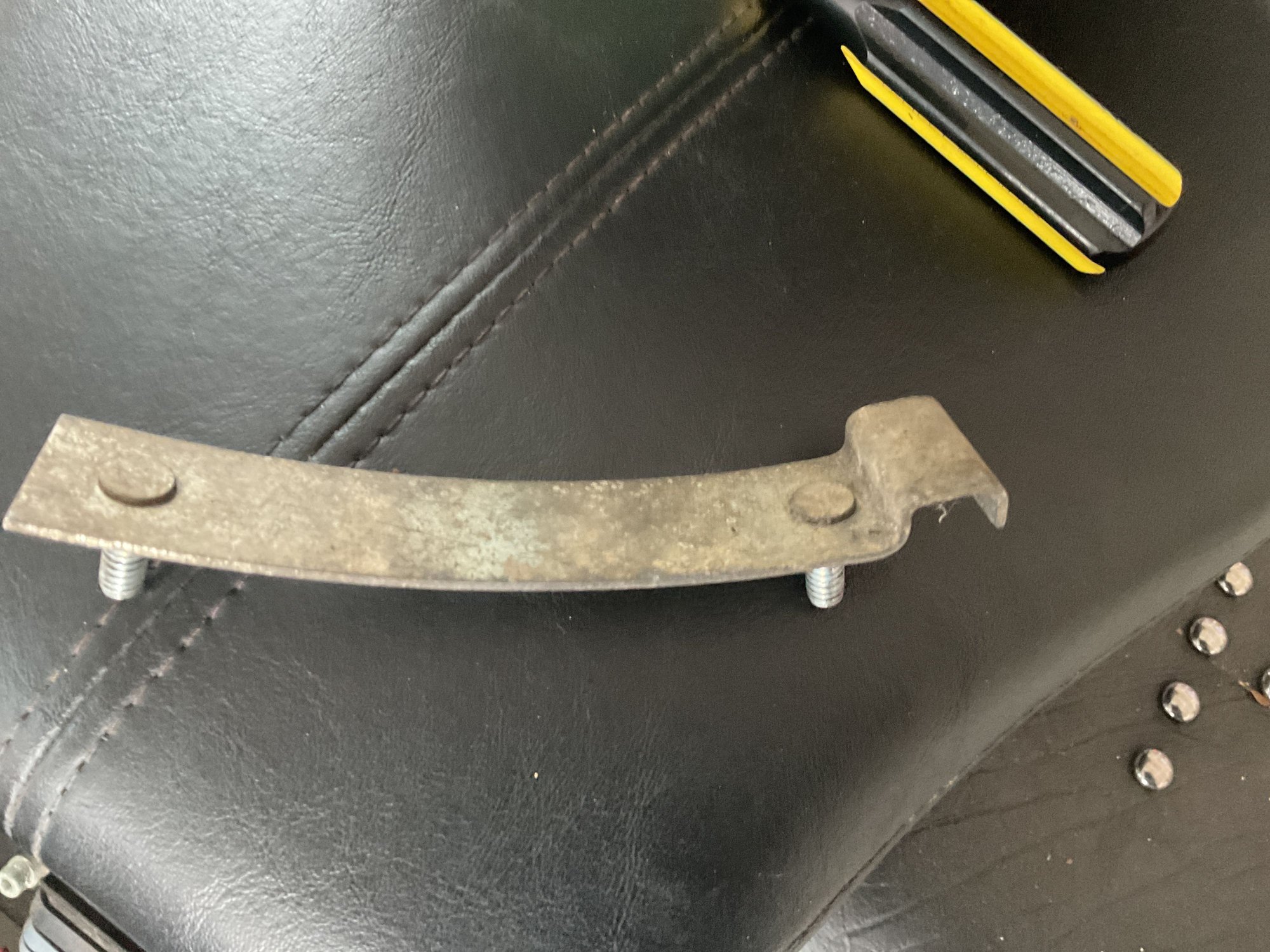 My friend replaced the battery on my 2010 Heritage and this piece was remaining afterwards.  I tried starting and the negative battery terminal turned bright red.  I tried ChatGPT and it says it�s the engine strap is causing this but the directions on its location was vague.  Can someone help and tell me where this goes?