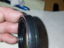 If you look close, the outer rightside of the fork oil seal has a slight ledge that sticks out, the side with the ledge faces down during installation. 