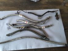 Here you can see the oil lines are really looking pretty sad ! They're not even all the same type ! The top line in this photo is the rear brake line that was replaced with an OEM NOS brake line.along with a new brake light switch .
