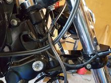 There is ample gap between the brake line and throttle cables