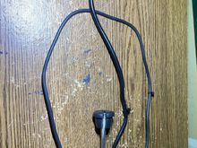 I opened the grommet-plug to transfer it to the USB cable.  There is a notch in the plug for a wire-tie that keeps the wire from slopping through.
