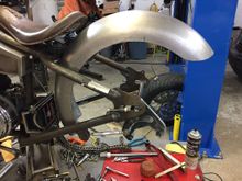 Got pieces from Speedway Motors for reaction link and caliper bracket trimmed down