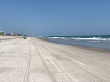 Beach runs East-West.  This is looking to the east.  The blue things are Shibumis.  I said I would never buy one because they cost too much for a bedsheet and a stick.  But I finally broke down and got one.  Check out the story on them at shibumishade.com   I have nothing to do with the company, but it's a cool story about young entrepreneurs.  