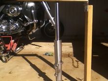 The horizontal top board pushes the cap down and into the fork tube so you can screw the cap in.  Don't us too much force, get it started, don't Xthread it. 