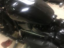 Install the two fuel tank bolts, cross under tube, and fuel line.