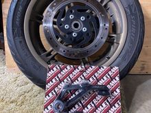 parts pile. original rotor still on wheel