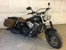 My "Heritage" Switchback. The Switchback shock tops (now obsolete, BTW) snap right onto the 412 Progressives.  HD saddlebags & seat with invisible modifications, Progressive front springs, HD 103 kit with S&S 583 E-Z's.
It's an '08; years before the Switchback...