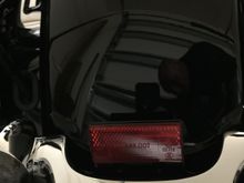 This is how mine is. And it looks like I'll have to crawl up the rear fender to unbolt the light bar in order to remove it.