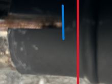 Muffler limited by the rear mounting bracket but still goes PAST the slip-on's cutouts (red line). The black shadow to the right of the blue line is not part of the cutout.