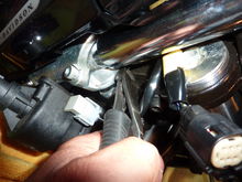 Cut the two zip ties that hold the brake and clutch lines to the steering head.