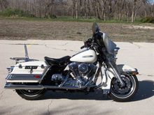 2005 FLHTPI 
Later addns: Stage 1 intake, some chrome, Kenwood marine stereo w/USB, cup (beer) holder, floating rotors, new tires, more chrome, bag rail inserts, fender rack, lower rear shocks, air seat gone, seat lowered, new windshield, bag hinges, FLHX mufflers, repositioned tank badges

Still to come: center stand, blue gauges, LEDs under bag rail inserts, oil cooler