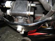 Front TT install much easier than rear. Jacked up bike, and used a 2nd jack on motor to relieve tension on motor mount bolts. Remove two nuts at top, mount TT bracket, then tighten/torque lock nuts.