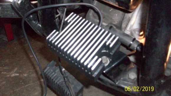 New voltage regulator in place. Note clutch cable clip and zip tied wrap on voltage regulator plug wires. I reused this from the original voltage regulator.