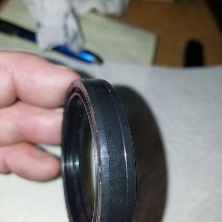 If you look close, the outer rightside of the fork oil seal has a slight ledge that sticks out, the side with the ledge faces down during installation. 