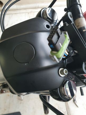 Remove the two nuts holding the headlight for better access to the cable