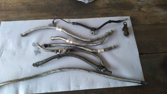 Here you can see the oil lines are really looking pretty sad ! They're not even all the same type ! The top line in this photo is the rear brake line that was replaced with an OEM NOS brake line.along with a new brake light switch .