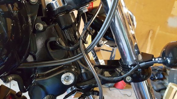 There is ample gap between the brake line and throttle cables