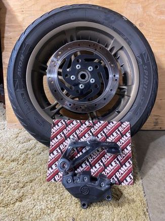 parts pile. original rotor still on wheel