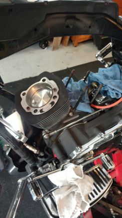 Had the jugs honed at a local machine shop. $42, wiped with clean engine oil, and slid the piston in and mounted it by sliding it down to get to the connecting rod and push the pin through. install remaining c-clip.  The other one I used a ring compressor.  I didn't have it available when i did the first one. Boy that makes it a lot easier.  