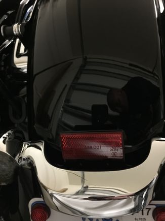 This is how mine is. And it looks like I'll have to crawl up the rear fender to unbolt the light bar in order to remove it.