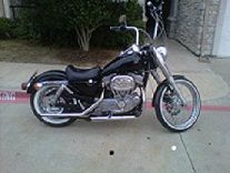 sportster with Fatboy front end, 21 inch spoke wheel with white walls, Apes, 80 spoke rear wheel with white wall and chrome sprocket cover added
