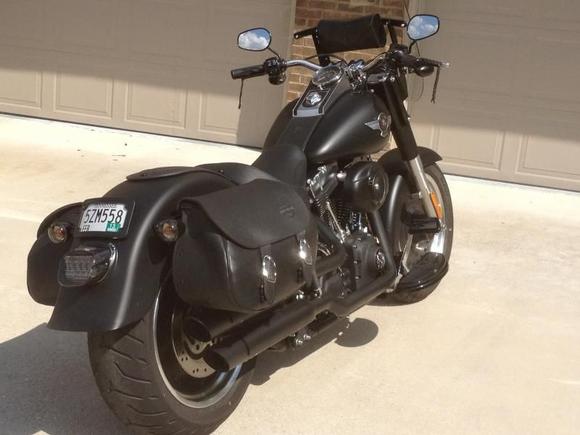 Tail end kept trim with lay down blacked out license frame, Black LED tail light, black lens turn signals, fender bib and HD saddle bags.