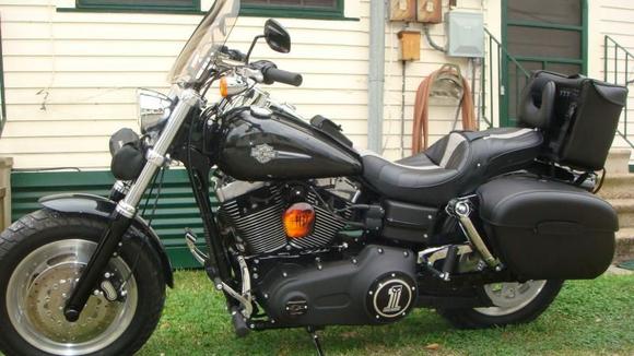 DSC01450 Medium Leatherman cruiser 2 sissybar bag holds my medium leather jacket with the insulated liner in it,and vest but no room left after that but gives you an idea how big it is. Took off most of the mounting system, but the center quick release strap works great with the hole in the Corbin backrest and the other two quick release straps secure it from moving around and i like the easy removal.