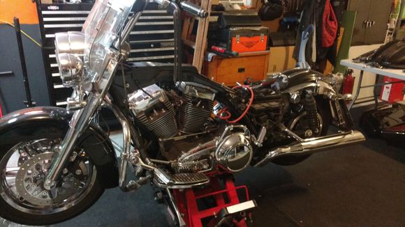 I set up a couple 6 ft tables to put the tins and stuff on, started taking off tank, seat, right floorboard, exhaust, etc