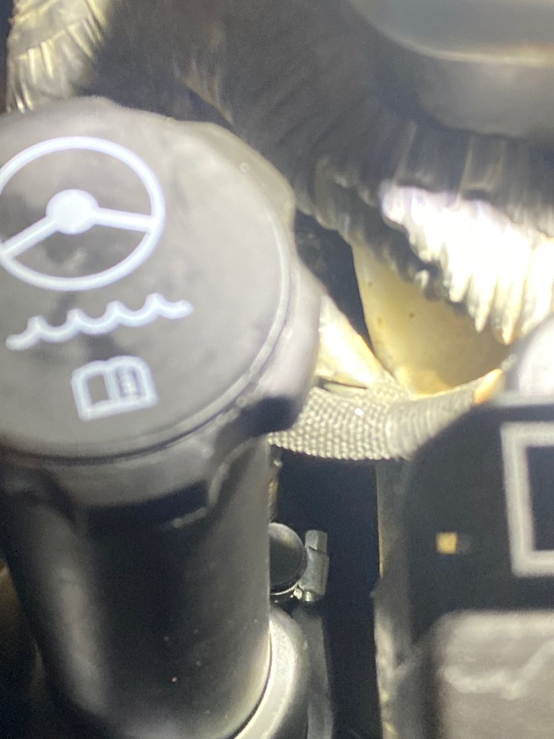 Rear nub on reservoir covered with a rubber cap and hose clamp.  