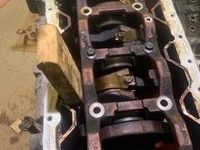 Wedging wood up against the crankshaft to hold it in place.  