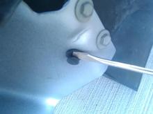 Remove plastic fasteners using a flat screwdriver