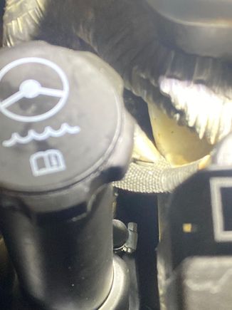 Rear nub on reservoir covered with a rubber cap and hose clamp.  