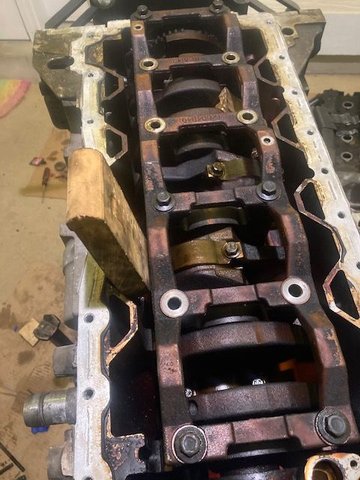 Wedging wood up against the crankshaft to hold it in place.  