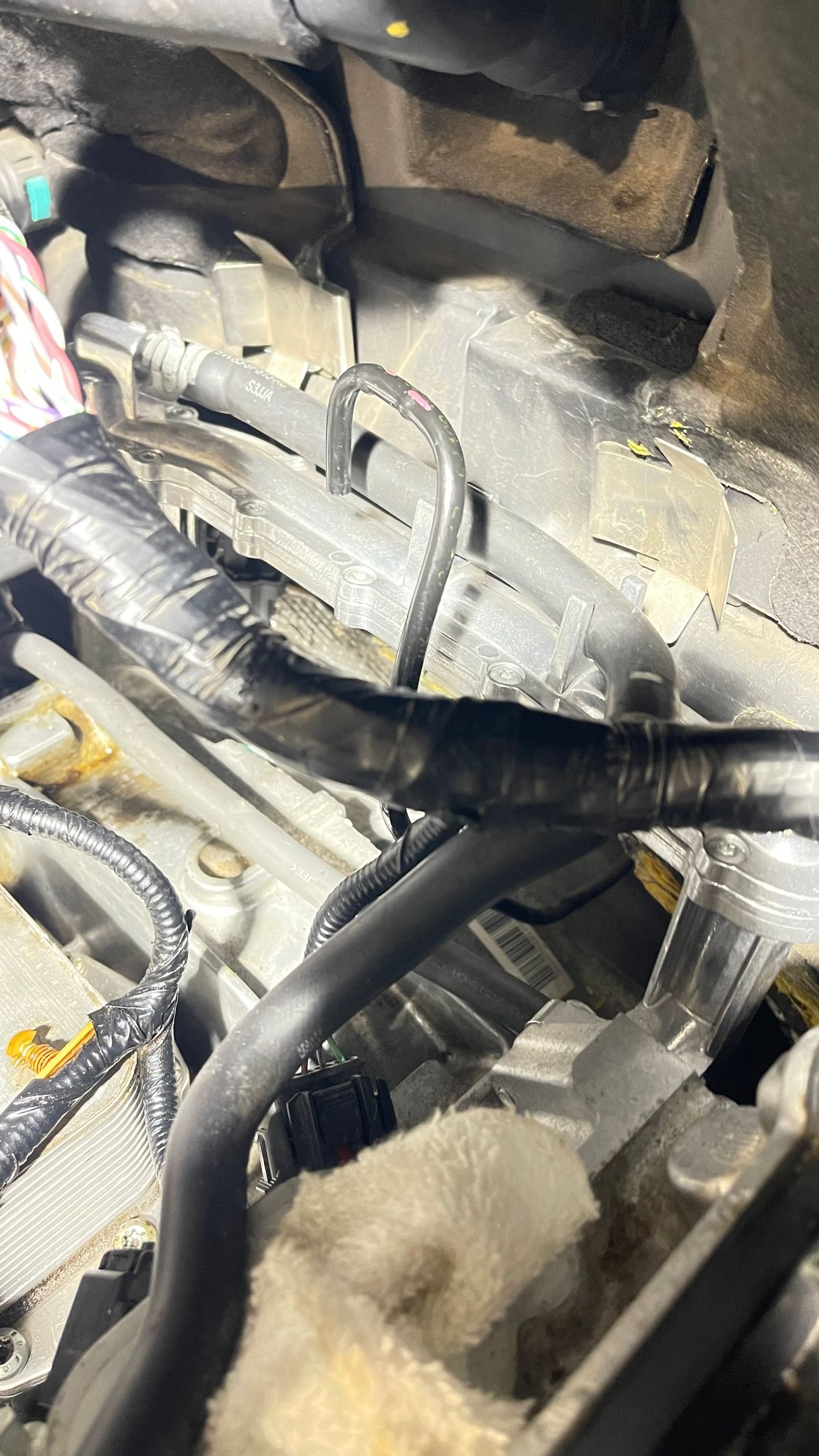 It is plastic. It is entirely possible that this was behind the coolant crossover pipe / plastic cable wire loom and that it was unconnected, and I just didn't see it. I was hoping someone had a diagram they could convince me with as I don't want to button everything up and have this be a source of problems.