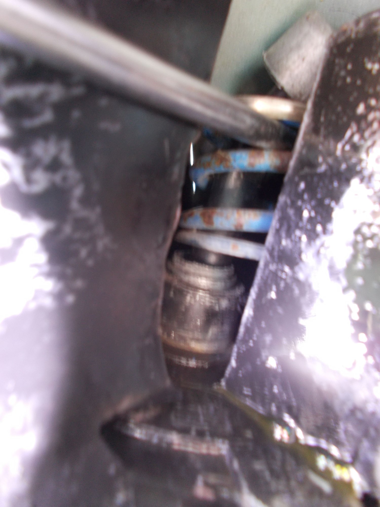 The Autopsy Report.  From bottom Up - The mount around which the spring seats - the bottom (3/4mm) of the post that the star washer grips onto - the spring - the top outside edge of the 