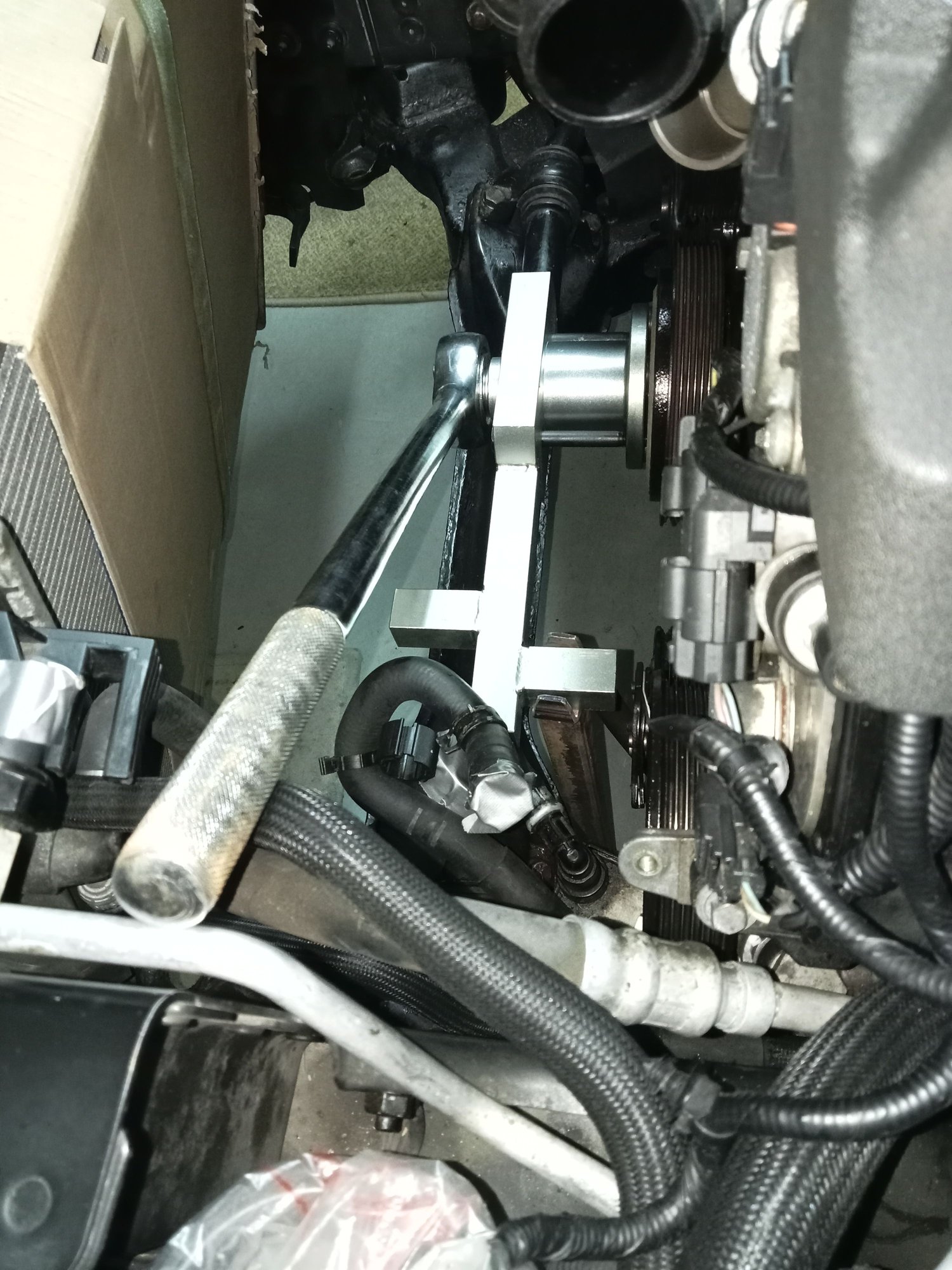 Crankshaft bolt removal tool. The free end is supported in the forked end of steel bar.