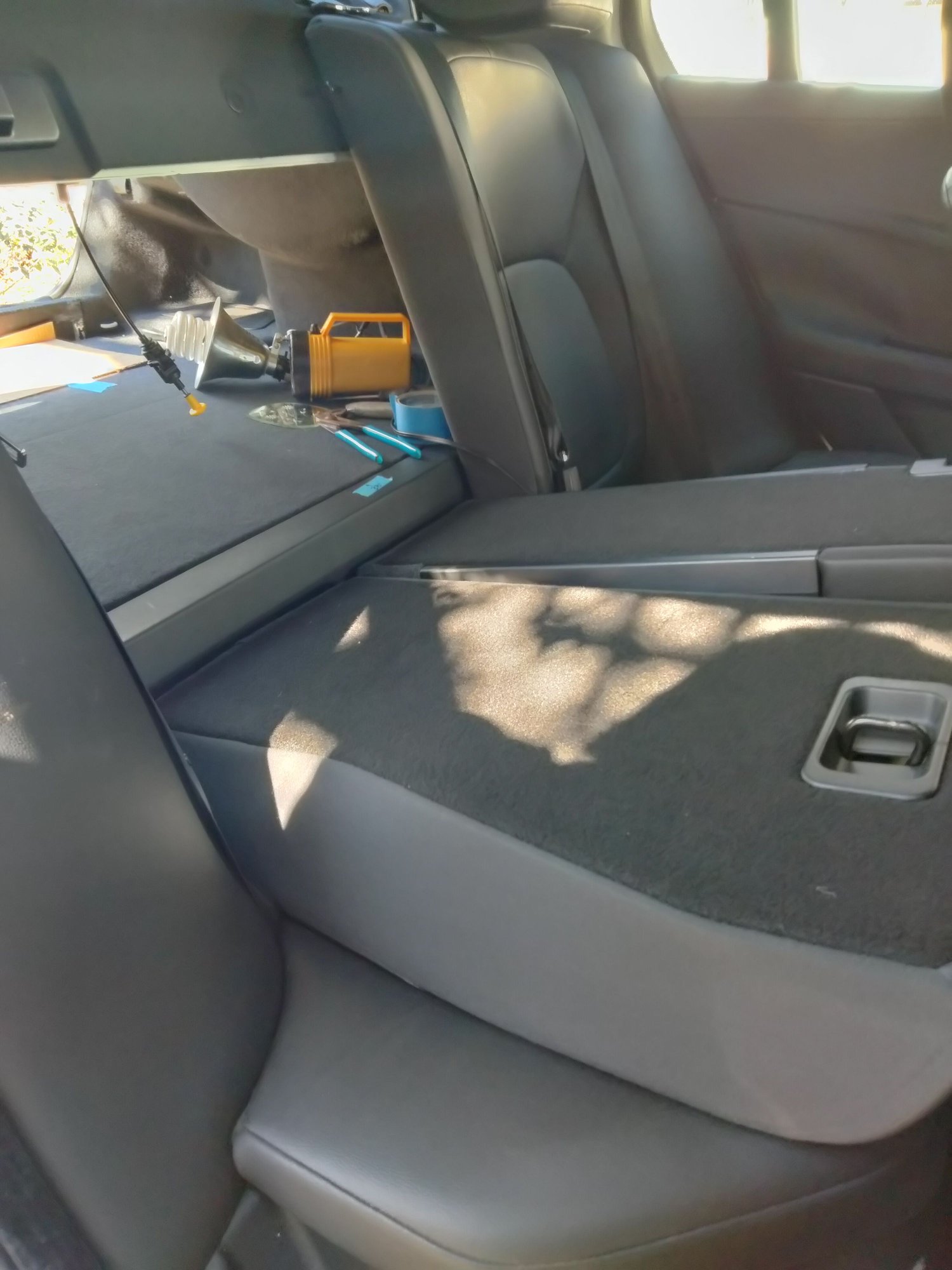 The rear passenger seatback release is hidden in the trunk