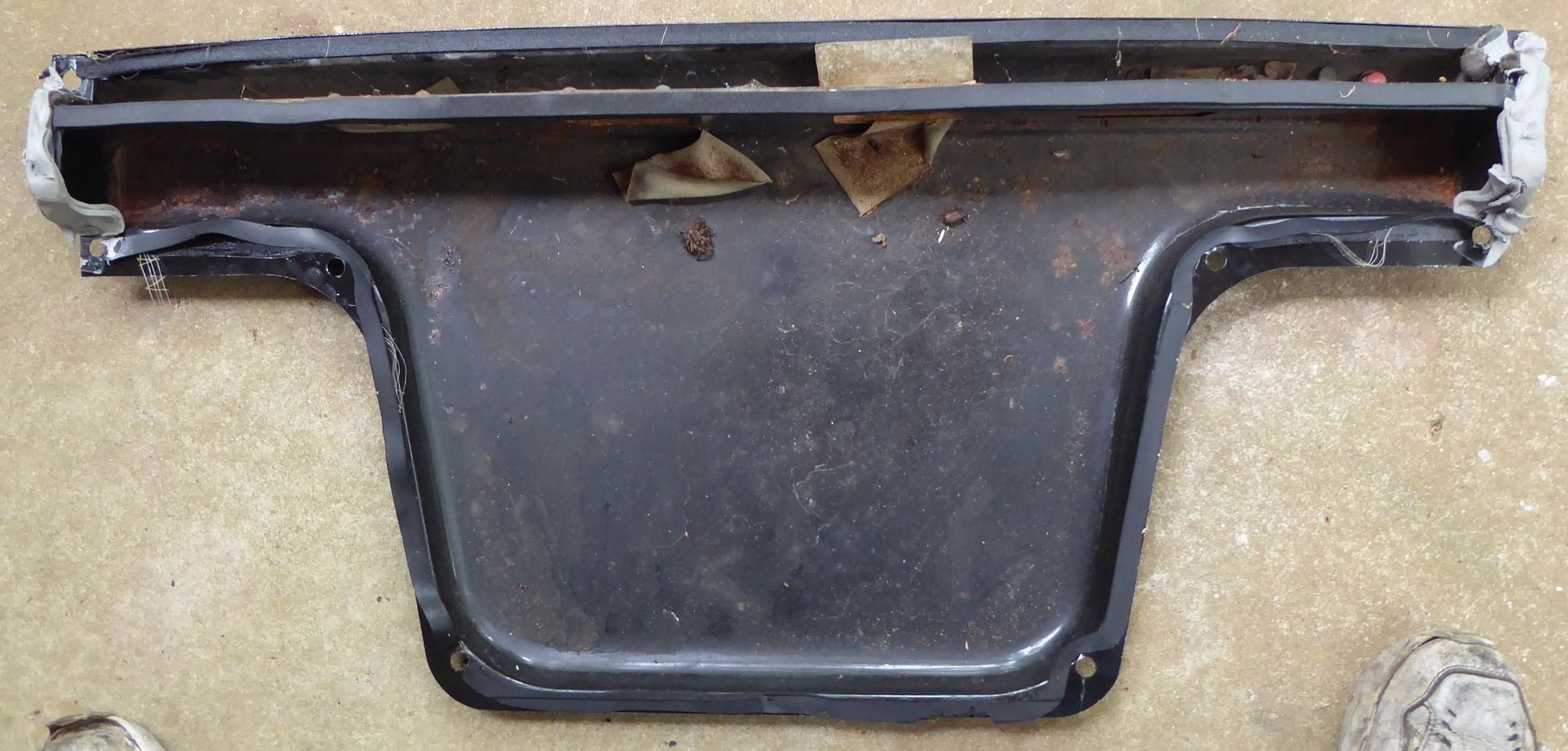 Rear tray as removed, top trough is where air goes from cabin to exit around boot lid. Notice thicker foam on top of divider as well as pile of gray putty on each end to seal the gaps when installed.