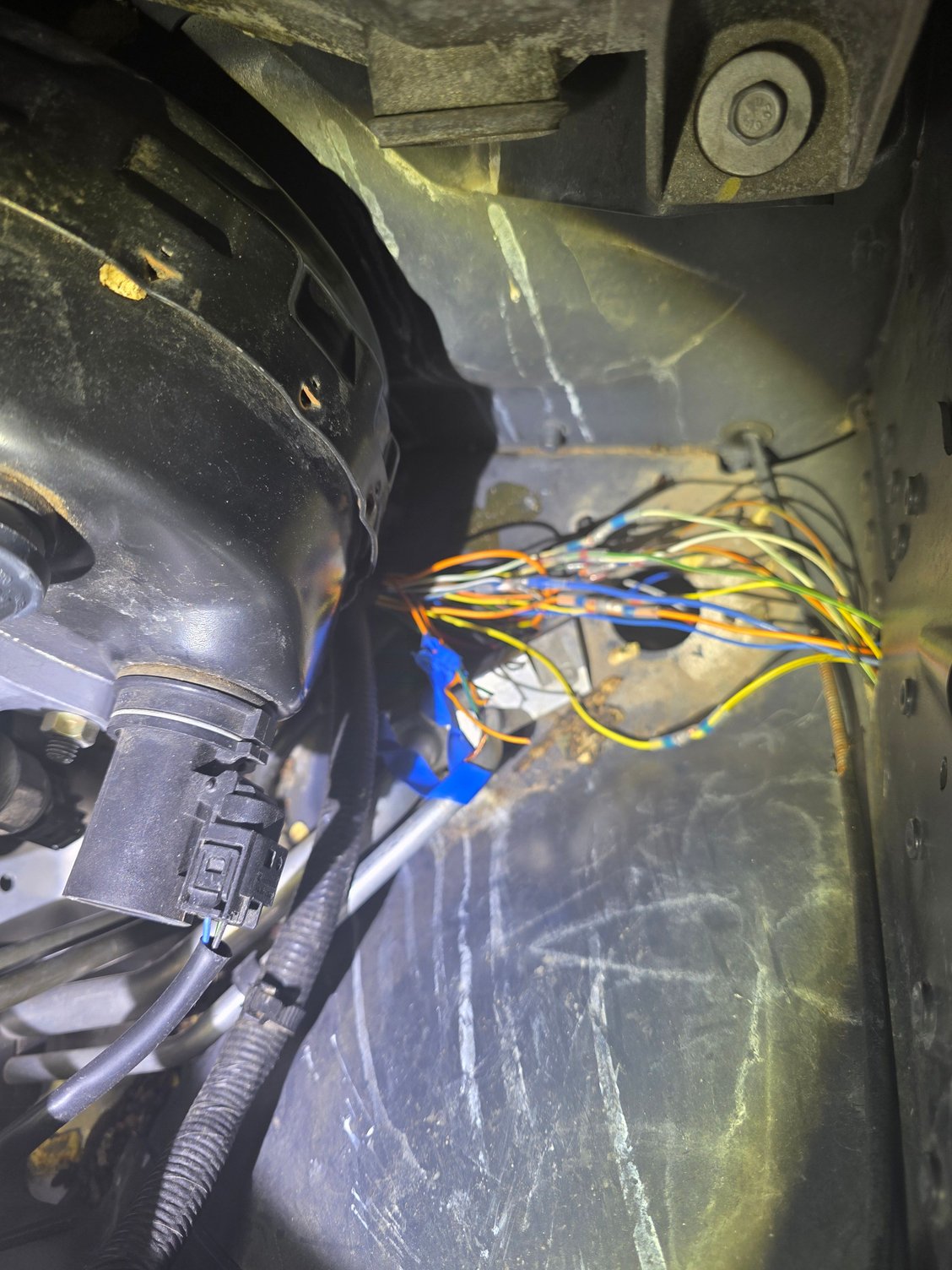 A semi-close up of area under the booster. in the daylight, a closeup of the wires under the booster, even closer in than this, might help. Again, my wires were re-routed and in a normal car would be a tight bundle.