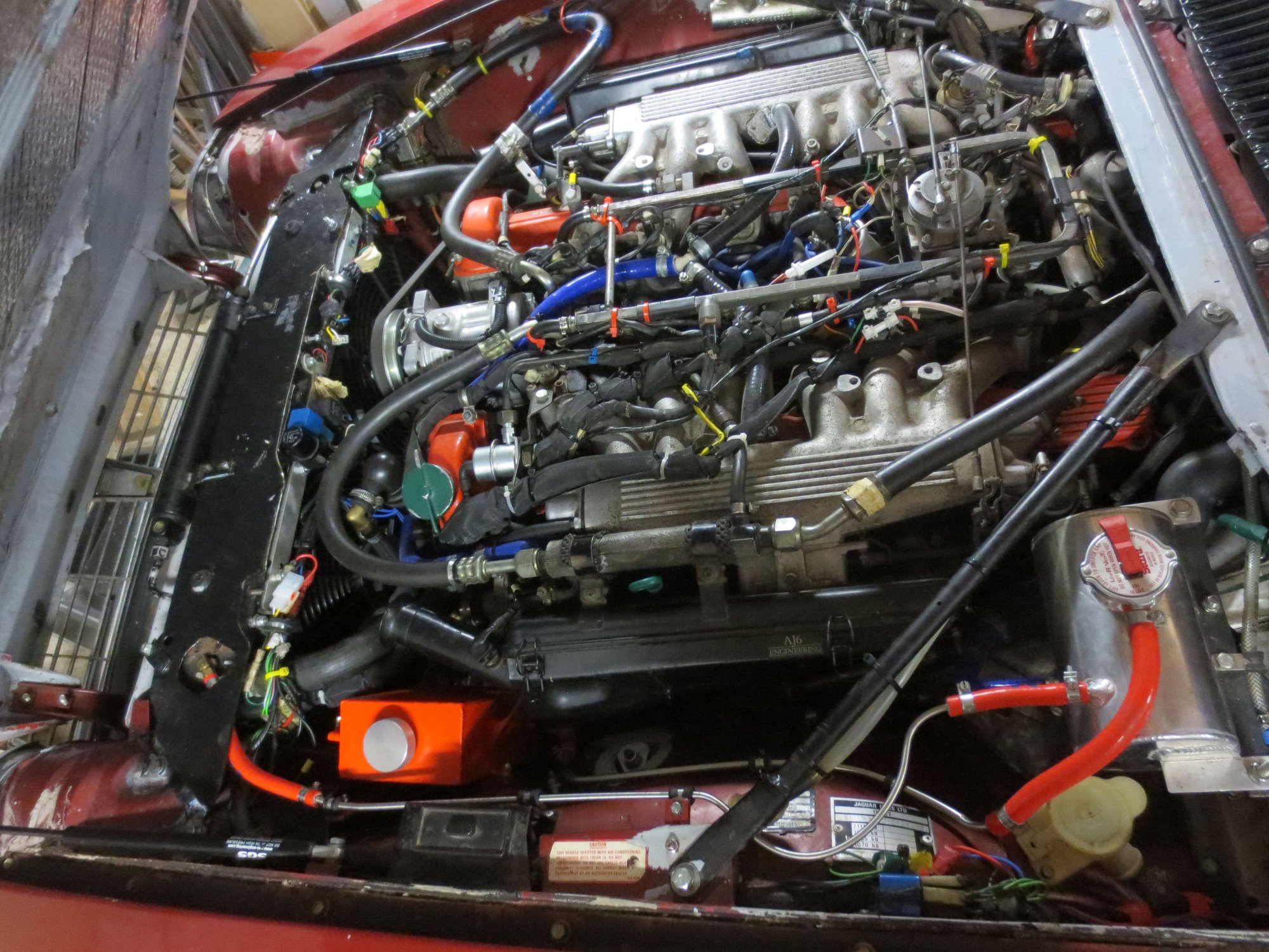 Overall shot of the system. You can see the stainless 4mm ID hr=ardline going slightly uphill from the radiator to the tank. The red  tank is the atmospheric overflow