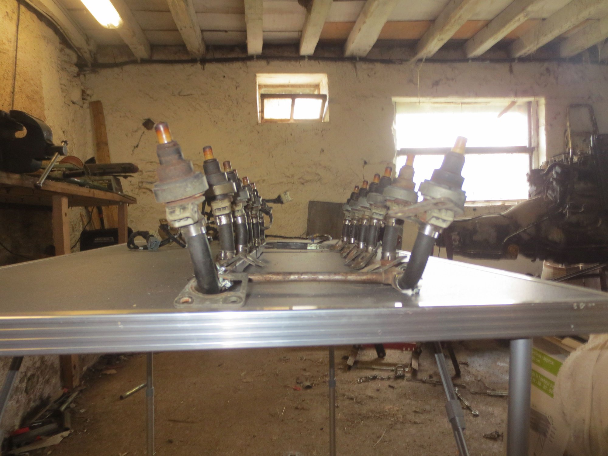 Shows the distinct outward splay of the injectors. The hole in the manifold is also angled to accept this angled insertion.