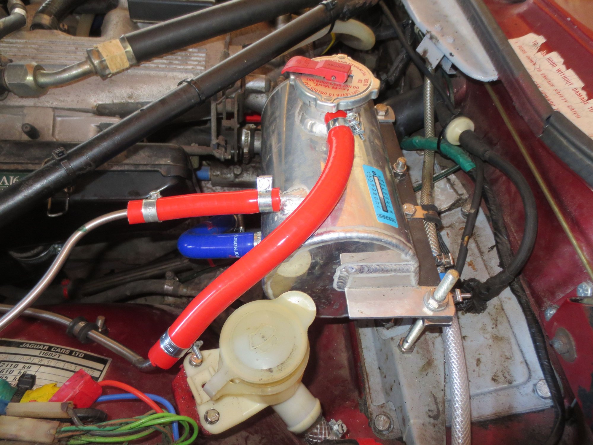 GiF coolant header: Rad bleed horizintal red pipe, atmo tank top curving down to the left pipe, feed to system plumbed into the heater return, blue pipe.