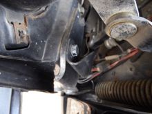 Left side springs with bent bracket, shock version does not have spring or open limit arm.