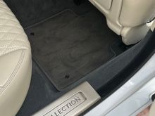 OEM mat in the rear passenger - notice how the OEM mat doesn't match the carpet any better than the Llyod's