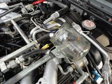 1A injector aimed in glass jar to confirm Noid Light failure to flash is failure of injector to flash.