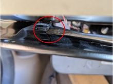 By pulling back on the bracket I was able to push the spring clip to the side to release the fastner.